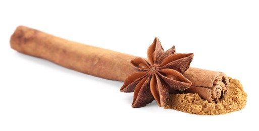 Photo of Dry aromatic cinnamon stick, powder and anise star isolated on white