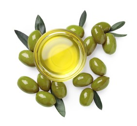 Photo of Cooking oil in bowl, olives and leaves on white background, top view