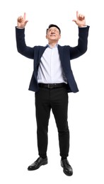 Businessman in suit posing on white background, low angle view