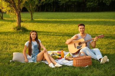 Photo of Happy couple having picnic in park on sunny day