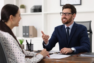 Photo of Woman having meeting with lawyer in office, selective focus