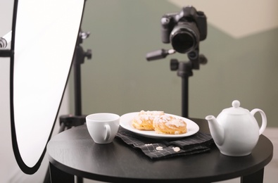 Photo of Professional camera on tripod and food composition in photo studio