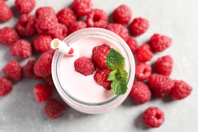 Image of Yummy raspberry smoothie in jar and fresh berries on table, flat lay 