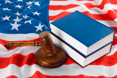 Photo of Judge's gavel and books on American flag
