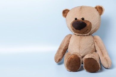 Photo of Cute teddy bear on light background, space for text