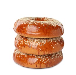 Photo of Delicious fresh bagels with sesame seeds on white background