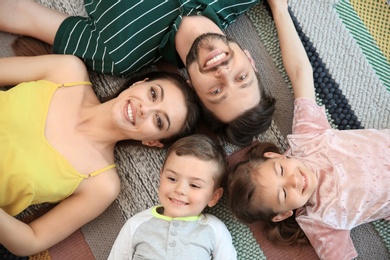 Photo of Portrait of happy family with children indoors, top view