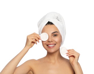 Photo of Young woman using cotton pads with micellar water on white background
