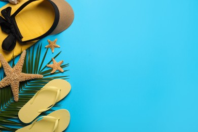 Photo of Flat lay composition with different beach objects on light blue background, space for text