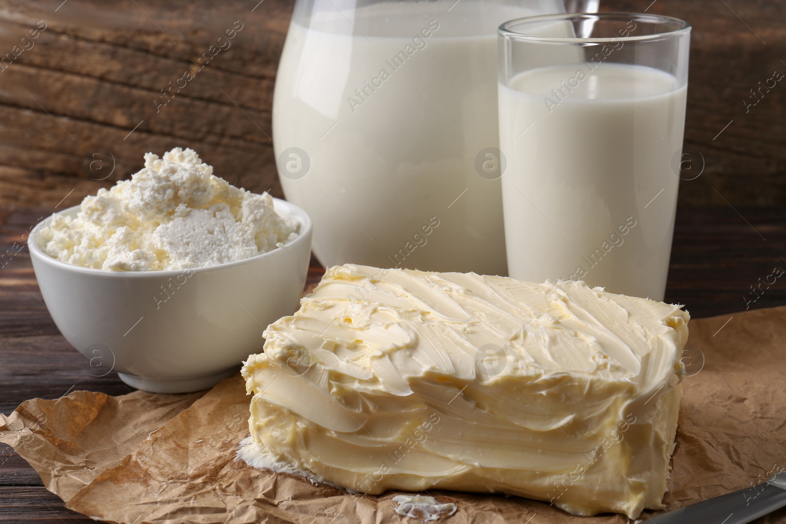 Photo of Tasty homemade butter and dairy products on wooden table, closeup