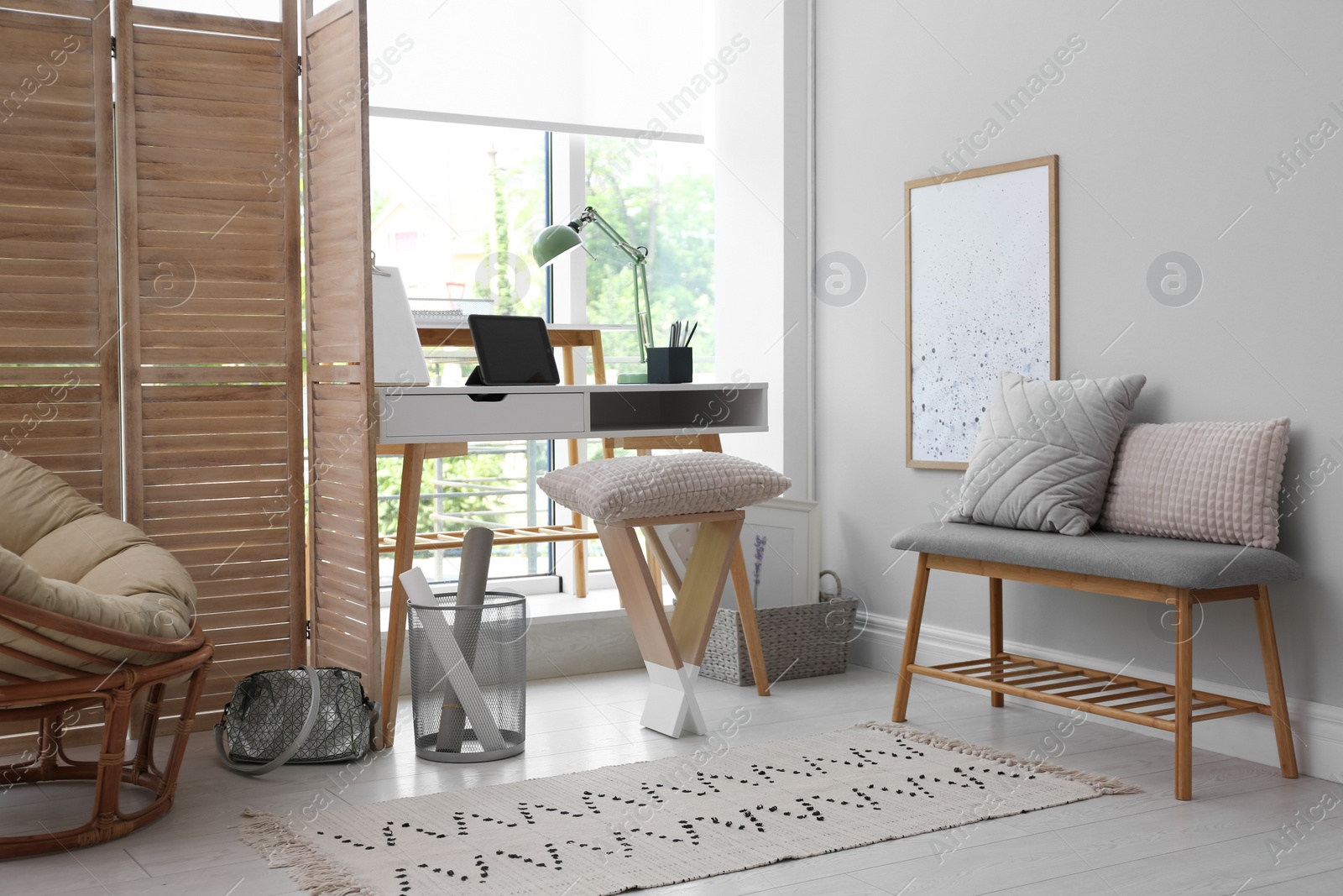 Photo of Stylish room interior with comfortable workplace near window