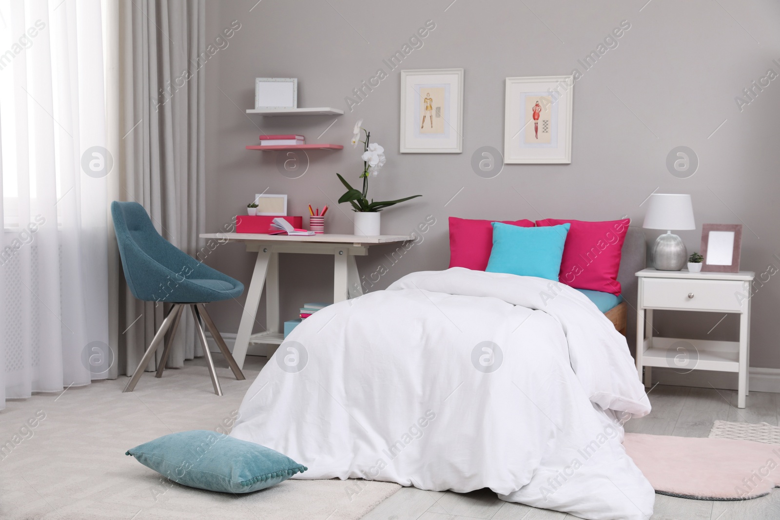 Photo of Modern teenager's room interior with comfortable bed and workplace