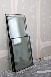 Photo of Double glazing windows on floor near wall indoors