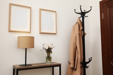 Photo of Bouquet with alstroemeria flowers on console table in modern hallway. Interior design