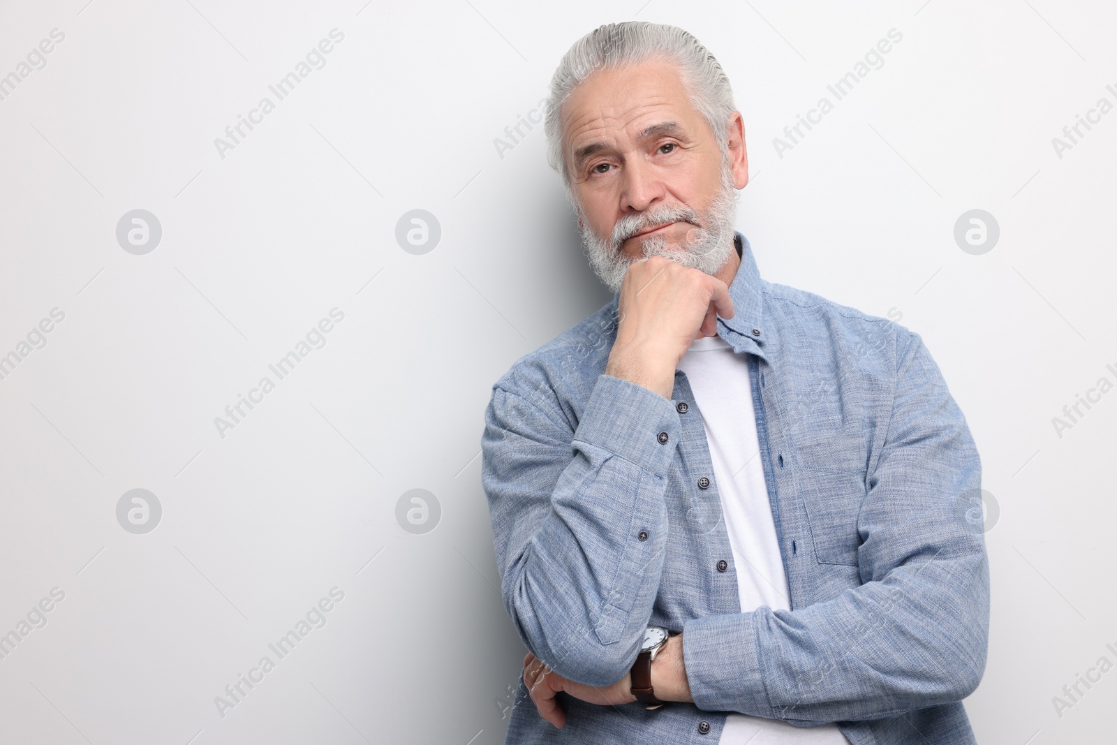 Photo of Portrait of handsome senior man on white background. Space for text