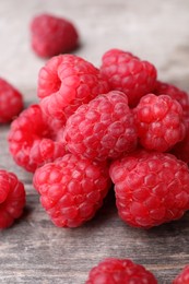 Tasty ripe raspberries on wooden table, closeup