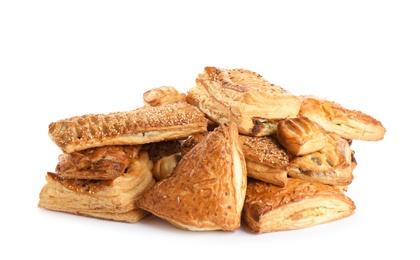 Heap of fresh tasty puff pastries on white background