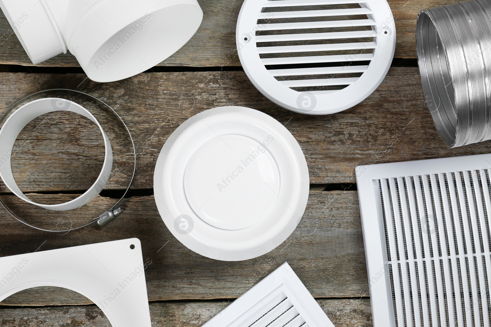 Photo of Parts of home ventilation system on wooden surface, flat lay