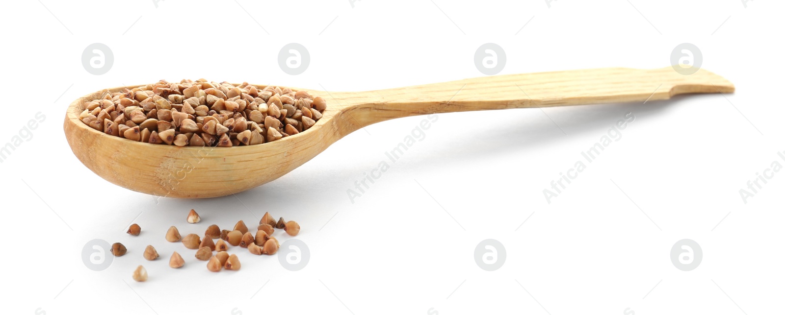 Photo of Spoon with raw buckwheat on white background. Healthy grains and cereals