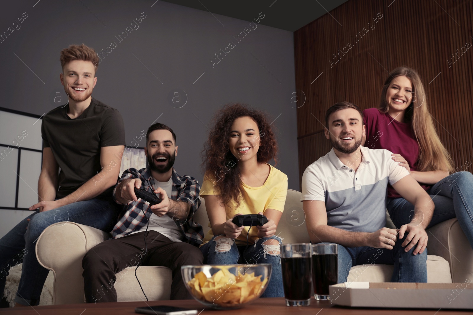 Photo of Emotional friends playing video games at home