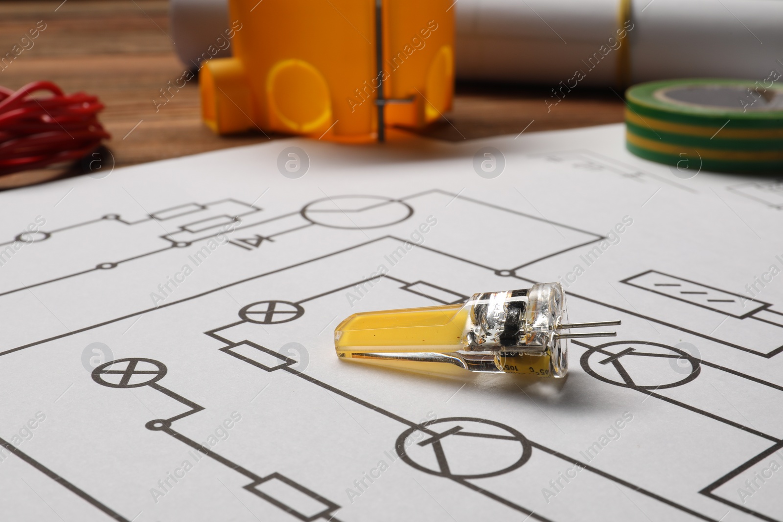 Photo of Wiring diagram and different electrician's equipment on table, closeup