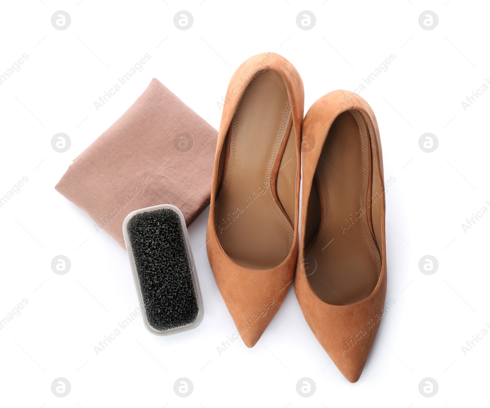 Photo of Stylish footwear and brush on white background, top view. Shoe care accessory