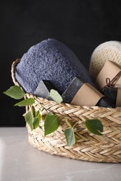 Natural tar soap in wicker basket on white table against black background