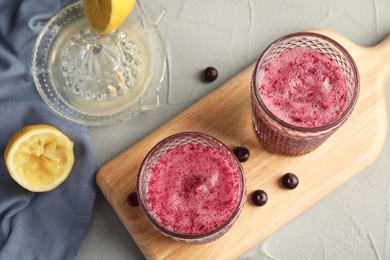 Photo of Flat lay composition with glasses of delicious acai juice on table