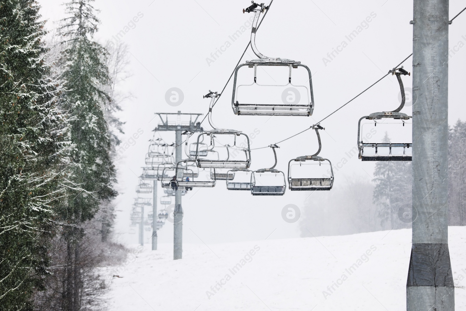 Photo of Ski lift at mountain resort. Winter vacation