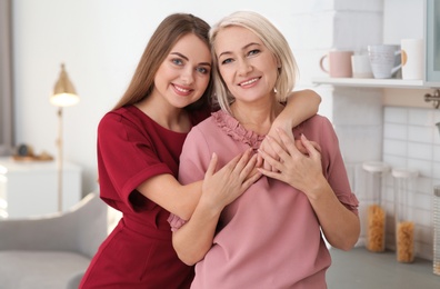 Photo of Portrait of mature woman and her daughter at home
