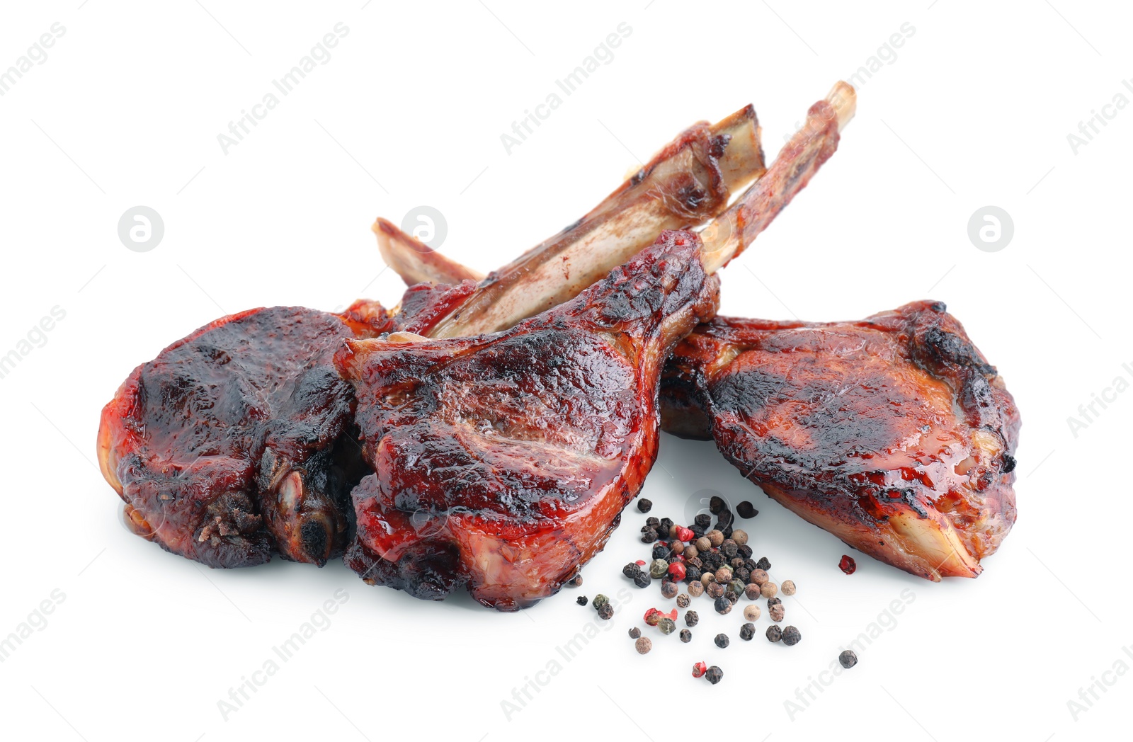 Photo of Pieces of delicious grilled beef meat and peppercorns isolated on white