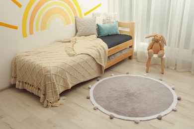 Photo of Stylish soft rug on floor in children's room