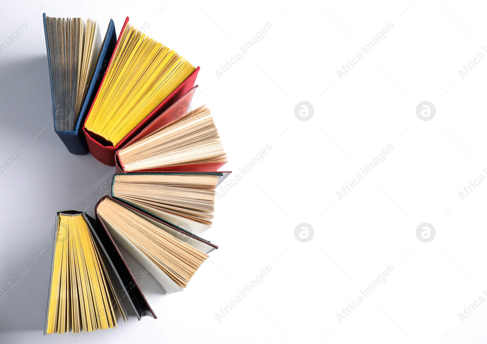 Photo of Hardcover books on white background, flat lay. Space for text