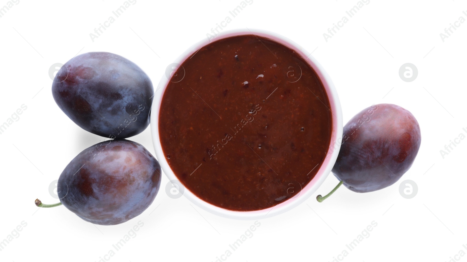 Photo of Plum puree in bowl and fresh fruits on white background, top view