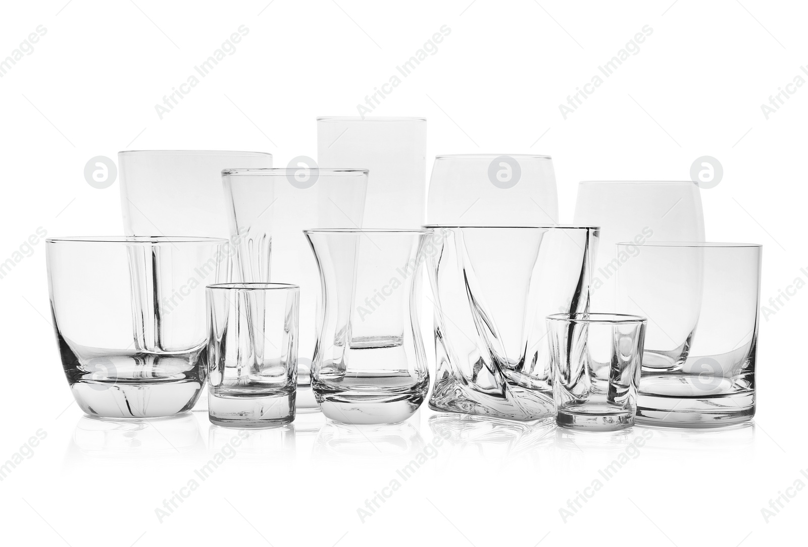 Photo of Set of empty glasses for different drinks on white background