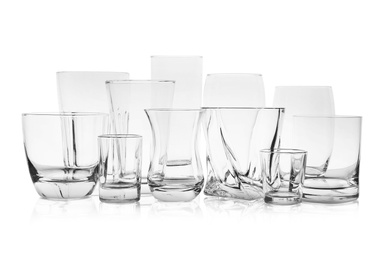 Set of empty glasses for different drinks on white background