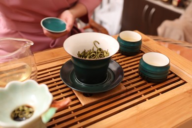 Photo of Traditional tea ceremony. Master near tools and tray, closeup