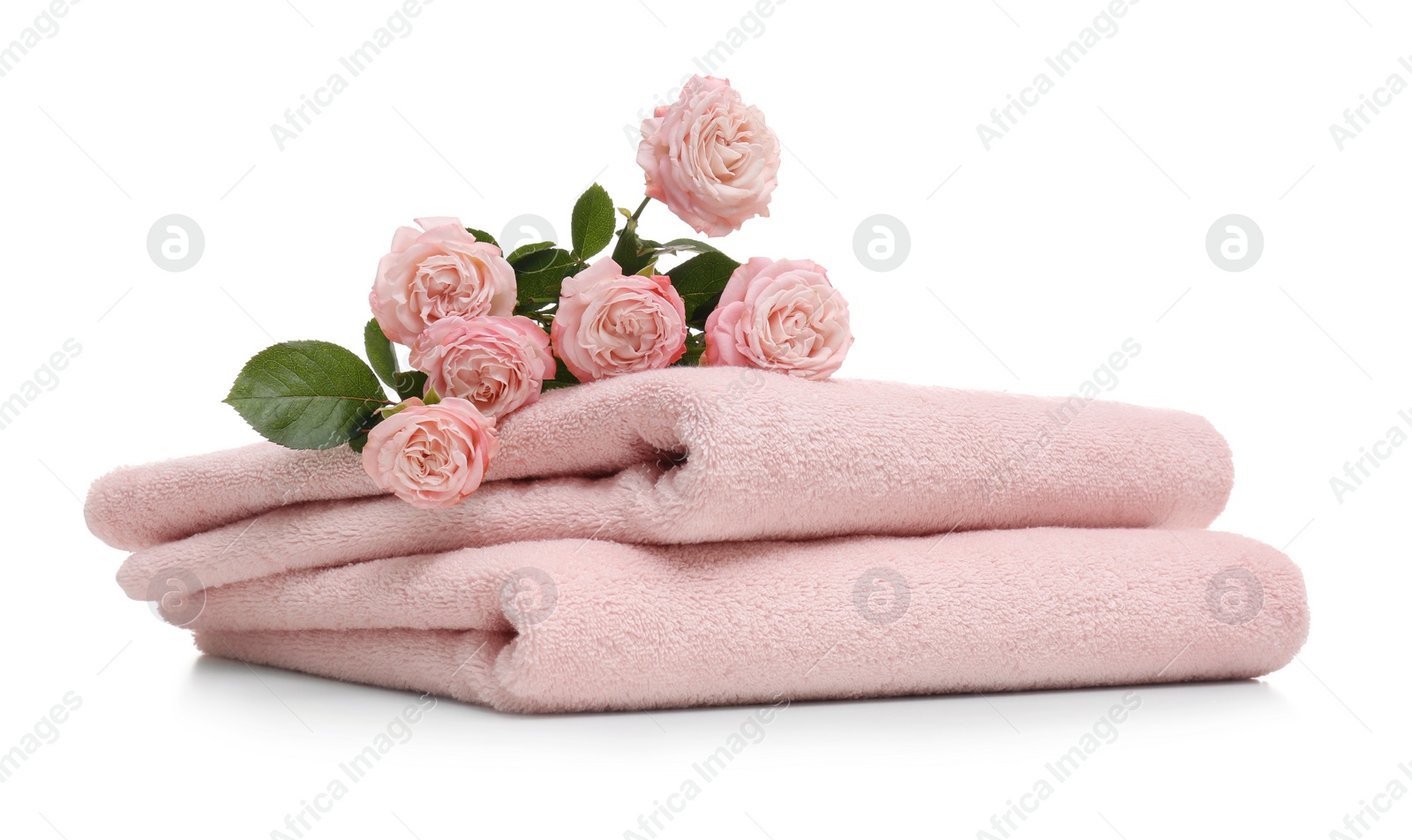 Photo of Clean folded towels with flowers on white background