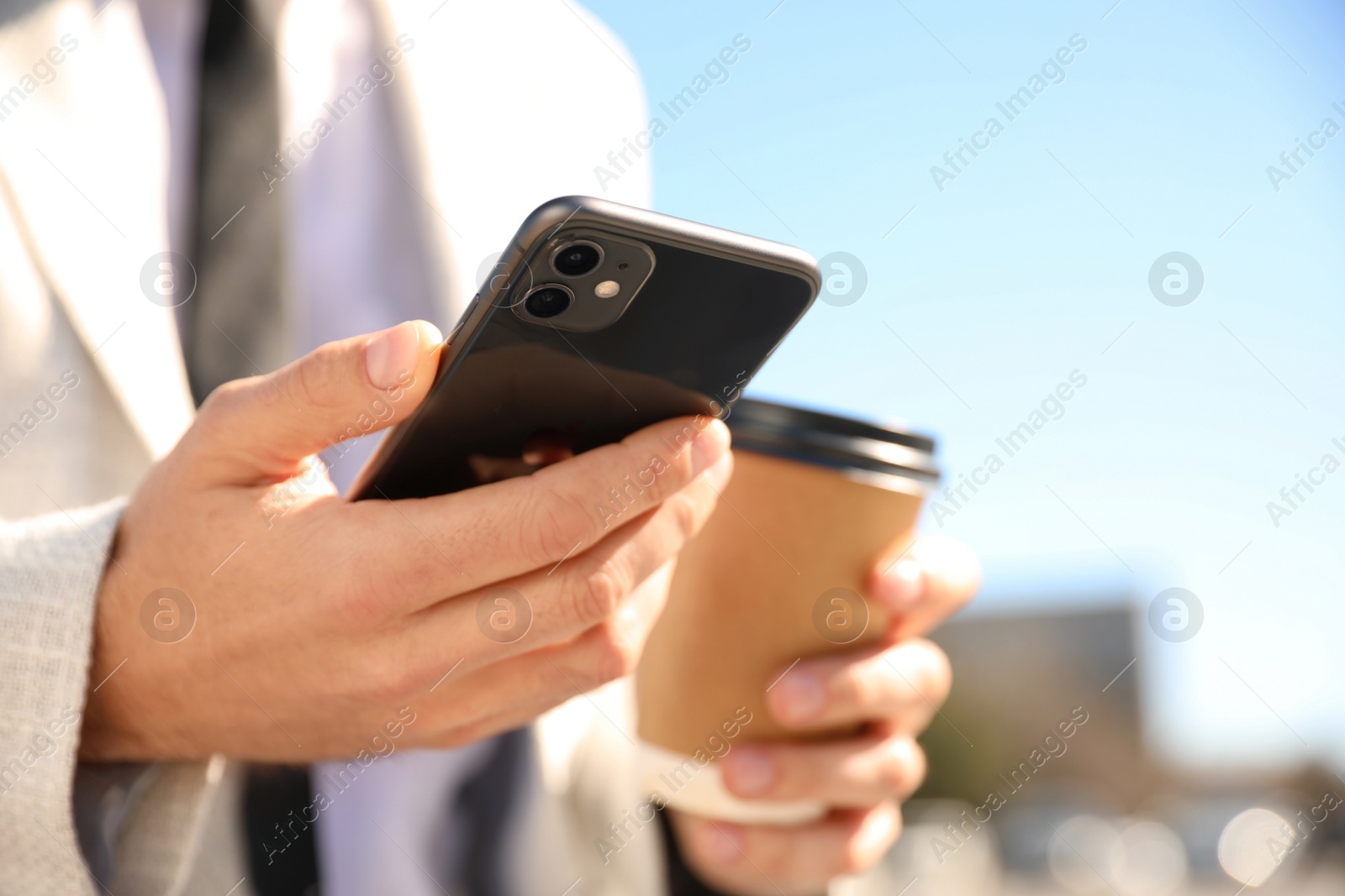 Photo of MYKOLAIV, UKRAINE - MARCH 16, 2020: Man holding iPhone 11 Black outdoors, closeup