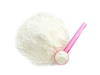 Photo of Powdered infant formula and scoop on white background, top view. Baby milk