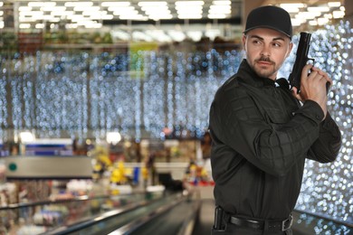 Male security guard wearing uniform with gun in shopping mall