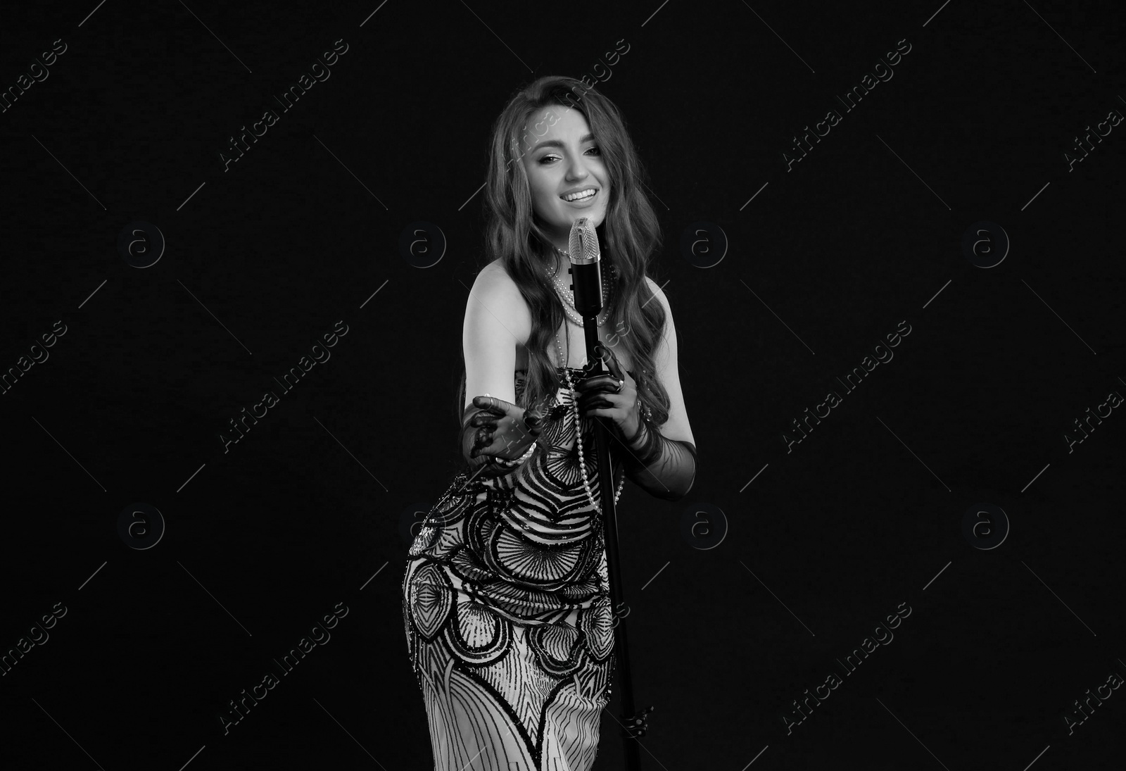 Image of Beautiful singer with microphone, black and white effect