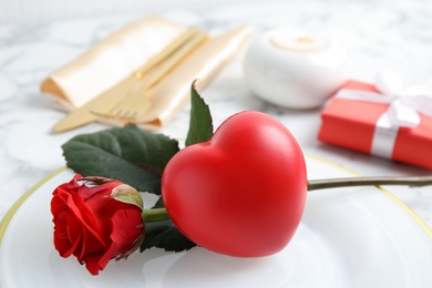 Photo of Beautiful table setting with decorative heart, closeup view. Valentine's day romantic dinner