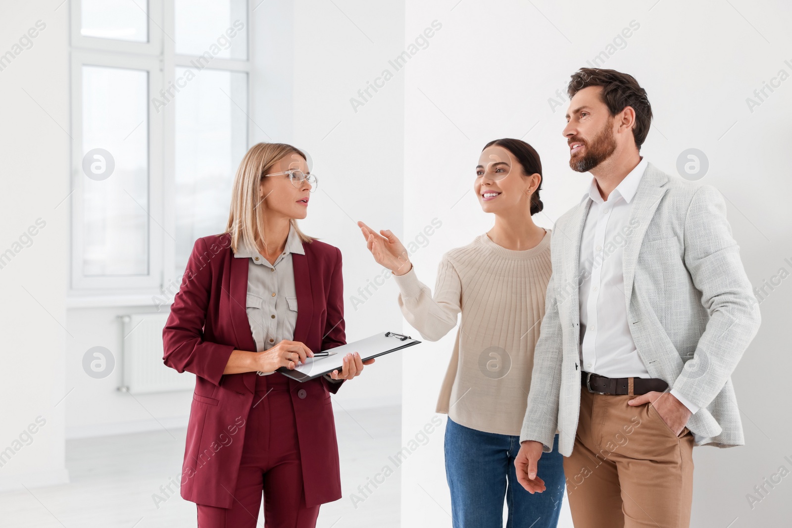 Photo of Real estate agent showing new apartment to couple