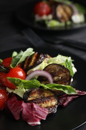 Photo of Delicious salad with roasted eggplant and basil on plate, closeup