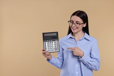 Smiling accountant with calculator on beige background, space for text