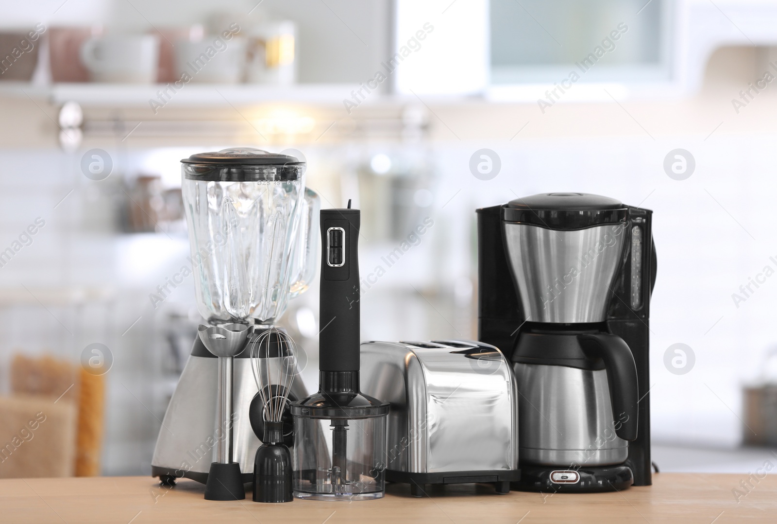 Photo of Different modern kitchen appliances on table indoors. Interior element