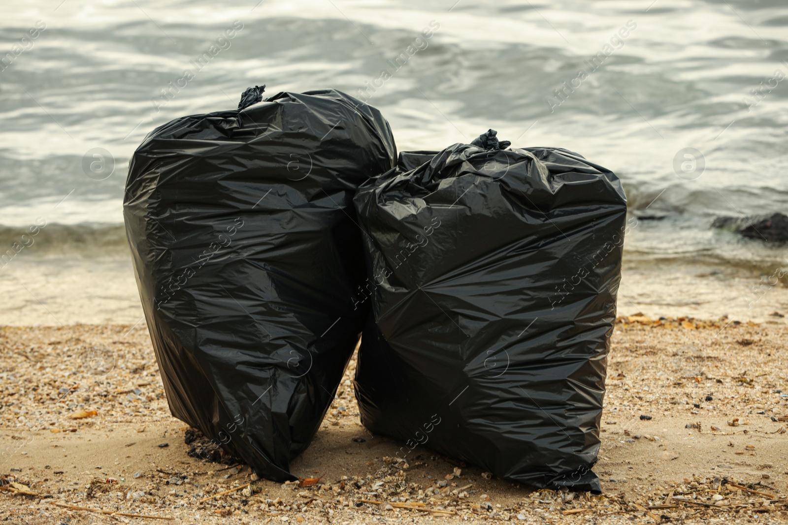 Photo of Trash bags full of garbage on beach