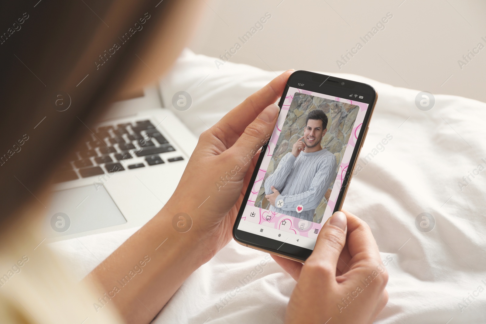 Image of Woman visiting dating site via smartphone indoors, closeup
