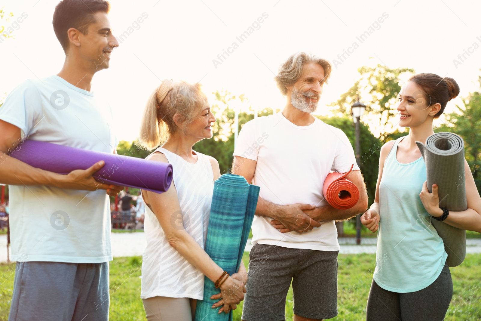 Photo of Group of people before morning yoga practice in park